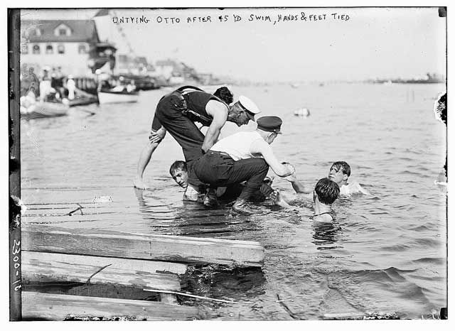 "Photo shows Vice Commodore Edward F. Otto, who gave swimming exhibitions in the New York City area with his hands tied behind his back." Photo taken around 1910. 